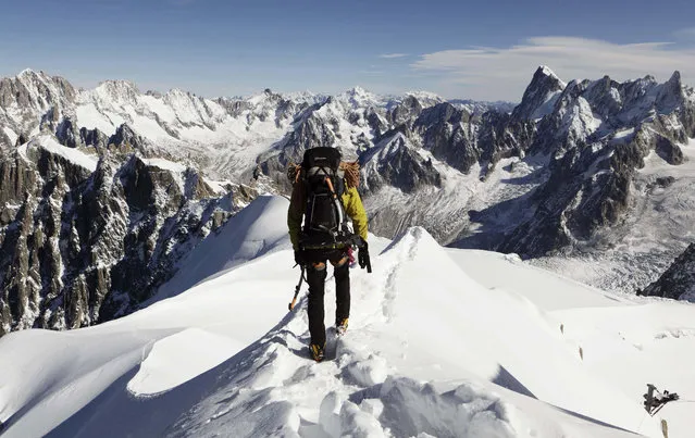 In this file photo taken on October 12, 2011, an alpinist heads down a ridge on the Aiguille du Midi (3,842 meters; 12 605 feet), towards the Vallee Blanche on the Mont Blanc massif, in the Alps, near Chamonix. French President Emmanuel Macron declared the battle against climate change and environmental destruction to be “the fight of the century” Thursday Feb. 13, 2020 after visiting a melting glacier in the Alps. (Photo by David Azia/AP Photo/File)
