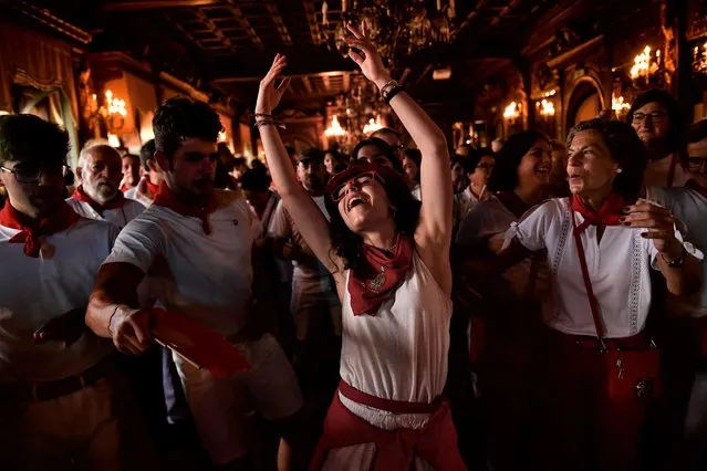 A woman dances “La Alpargata” at the end of the first day of the running of the bulls at the San Fermin festival in Pamplona, northern Spain, early Thursday, July 7, 2022.(Photo by Alvaro Barrientos/AP Photo)