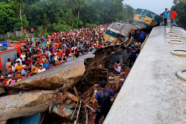 People gather near badly damages coaches after two speeding trains collided in in Brahmanbaria district, 82 kilometers (51 miles) east of the capital, Dhaka, Bangladesh, Tuesday, November 12, 2019. More than a dozen people were killed and scores were injured. (Photo by Xinhua News Agency/Barcroft Media)