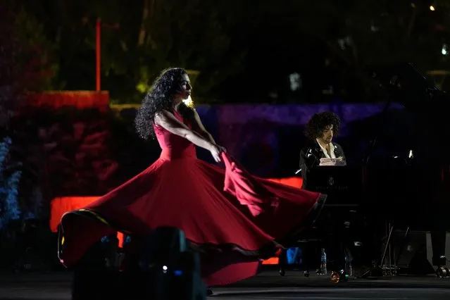 French Pianist Simon Ghraichy performs next to French-Iranian dancer Rana Gorgani during a concert in the ancient northeastern city of Baalbek, Lebanon, Sunday, July 17, 2022. Lebanon's renowned Baalbek Festival is back, held in front of a live audience for the first time in two years amid an ongoing economic meltdown. (Photo by Hassan Ammar/AP Photo)