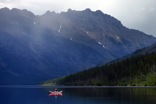 In this Sunday, July 10, 2016, photo, a lone fisherman glides along on Kintla Lake in North Glacier National Park, Mont. (Photo by Brenda Ahearn/The Daily Inter Lake via AP Photo)