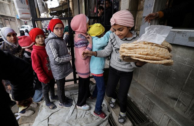 Children line up to buy bread, after Syria's Bashar al-Assad was ousted, in Douma, on the outskirts of Damascus, Syria on December 23, 2024. (Photo by Zohra Bensemra/Reuters)