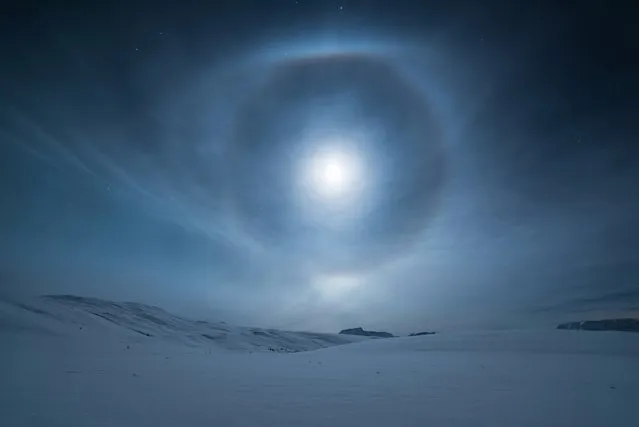 “Crystal Brilliance”. A mesmerising lunar halo forms around our natural satellite, the moon, in the night sky above Norway. The halo, also known as a moon ring or winter halo, is an optical phenomenon created when moonlight is refracted in numerous ice crystals suspended in the atmosphere. (Photo by Tommy Richardsen/Royal Observatory Greenwich’s Astronomy Photographer of the Year 2016/National Maritime Museum)