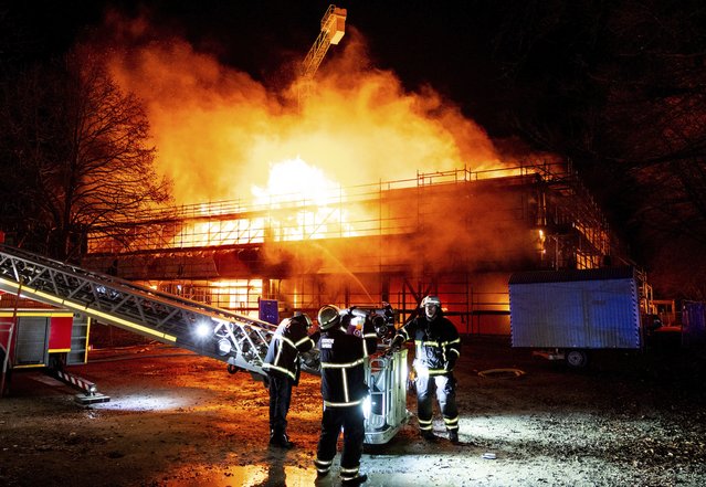 Firefighters extinguish a burning new school building in the Lohbrügge district of Hamburg, Germany, Monday, January 6, 2025. (Phoot by Daniel Bockwoldt/dpa via AP Photo)
