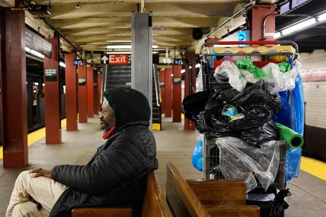 Sylver, who is homeless, sits with his belongings in a New York subway station in New York, April 14, 2020. Sylver is in his 50s, an immigrant from Nigeria, a member of the Ibo tribe. He's lived on the streets for 12 years. Afraid of the coronavirus in shelters, many of New York's homeless are sleeping on ghost trains and on platforms abandoned during the lockdown. (Photo by Lucas Jackson/Reuters)