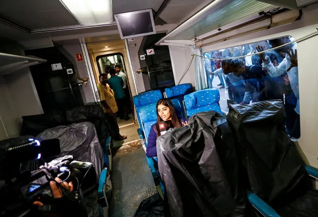 A television journalist reports from inside the parked high speed Talgo train during its trial run at a railway station in Mumbai, India August 2, 2016. (Photo by Danish Ismail/Reuters)