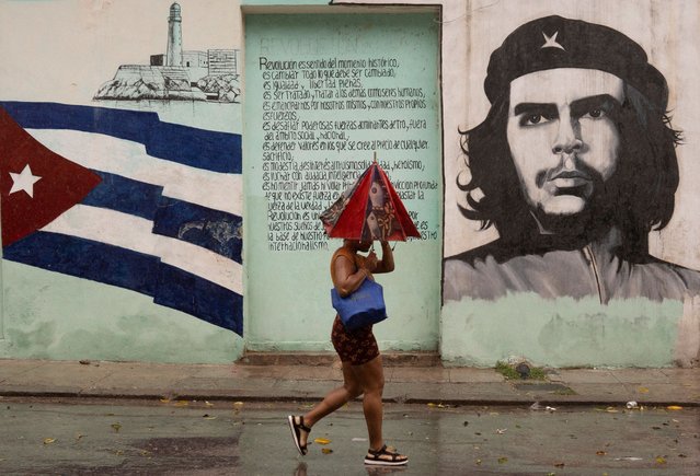 A woman walks on the street as Hurricane Rafael passes by Havana, Cuba, on November 6, 2024. (Photo by Alexandre Meneghini/Reuters)