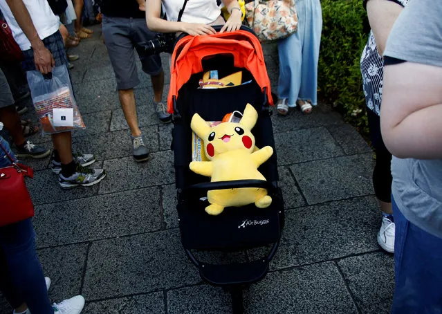 A woman pushes a baby stroller with a Pokemon character Pikachu doll in Yokohama, Japan, August 7, 2016. (Photo by Kim Kyung-Hoon/Reuters)