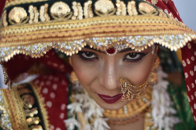 A Hindu bride attends a mass marriage ceremony in Karachi, Pakistan, 12 January 2025. Over 100 Hindu couples participated in a mass wedding ceremony organized by the Pakistan Hindu Council (PHC) on 12 January, aimed at alleviating the financial burden of wedding expenses for economically disadvantaged families. This event, part of an annual tradition established 16 years ago, involves a selection process where applicants are shortlisted based on their income and social status. (Photo by Shahzaib Akber/EPA)