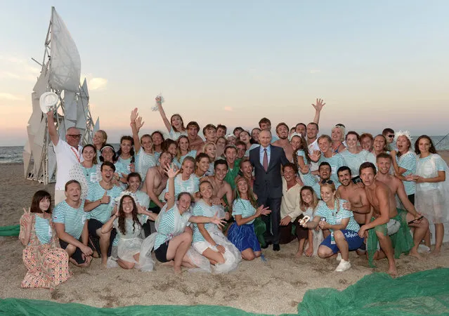 Russian President Vladimir Putin poses for a family photo with participants of the Tavrida (Taurida) national youth educational forum in Bakal Spit, Crimea, August 19, 2016. (Photo by Alexei Nikolsky/Reuters/Sputnik/Kremlin)