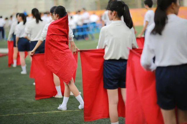 In this September 26, 2017, photo, students practice flag cheering routines at a Korean high school in Tokyo. Many third- and fourth-generation descendants of Koreans brought to Japan during the imperialist years before and during World War II remain loyal to their roots. (Photo by Eugene Hoshiko/AP Photo)