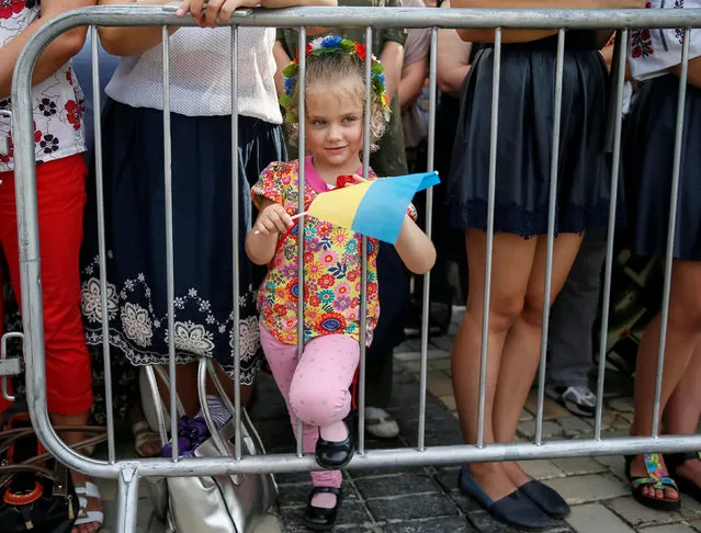 A girl attends a ceremony marking the Day of the State Flag, on the eve of the Independence Day, in Kiev, Ukraine, August 23, 2016. (Photo by Gleb Garanich/Reuters)