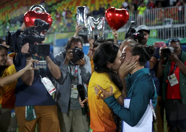 2016 Rio Olympics, Rugby, Women's Gold Medal Match Australia vs New Zealand, Deodoro Stadium, Rio de Janeiro, Brazil on August 8, 2016. Rugby player Isadora Cerullo (BRA) of Brazil kisses Marjorie, a volunteer, after receiving her wedding proposal on the sidelines of the women's rugby medal ceremony. (Photo by Alessandro Bianchi/Reuters)