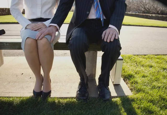 Man and woman sitting on a park bench, hand On knee. (Photo by Sampatrickstock/Getty Images)