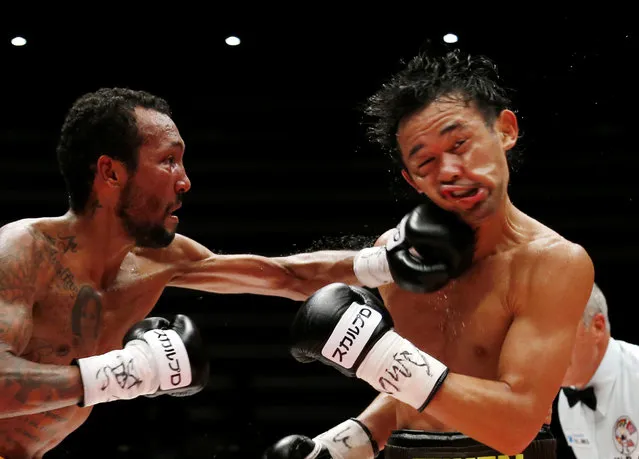 Japanese champion Shinsuke Yamanaka, right, gets a punch from Panama's challenger Anselmo Moreno in the eighth round of their WBC bantamweight boxing title match in Tokyo, Tuesday, September 22, 2015. Yamanaka defended his title by a 2-1 decision. (Photo by Toru Takahashi/AP Photo)