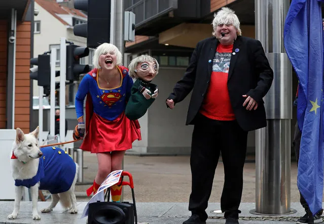 Britain's anti-Brexit activists Madeleina Kay, who nicknamed herself as “EU Supergirl”, and Drew Galdron, who is also an impersonator of British Foreign Secretary Secretary Boris Johnson, perform outside the European Commission headquarters in Brussels, Belgium December 8, 2017. (Photo by Yves Herman/Reuters)