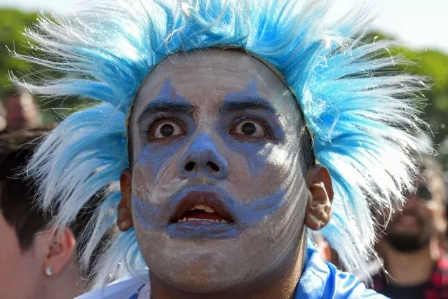 An Argentina soccer fan watches the team lose to Saudi Arabia at a World Cup Group C soccer match, played on a large screen in the Palermo neighborhood of Buenos, Aires, Argentina, early Tuesday, November 22, 2022. (Photo by Gustavo Garello/AP Photo)
