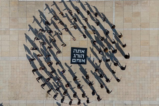 Activists takes part in a performance in Tel Aviv, Israel, calling to stop the war and for the release the hostages being held in Gaza, Friday, January 10, 2025. (Photo by Ohad Zwigenberg/AP Photo)