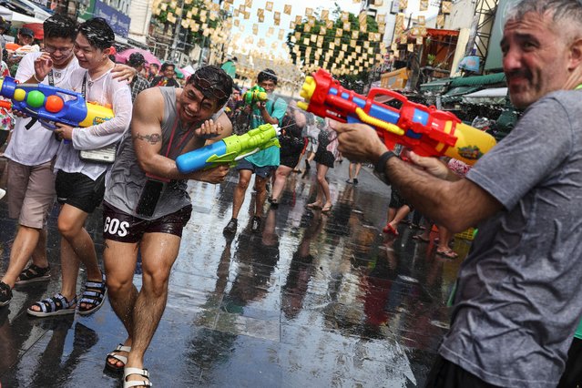 Revellers play with water guns as they celebrate the Songkran holiday, which marks the Thai New Year, in Bangkok, Thailand, on April 12, 2025. (Photo by Chalinee Thirasupa/Reuters)