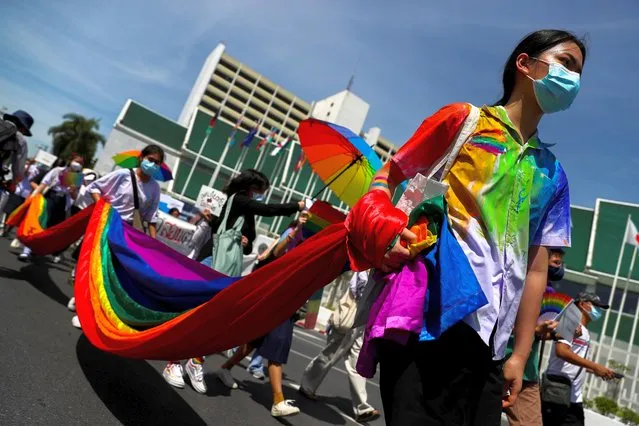 Members of a youth pride student group hold an LGBT flag during a rally for gender rights in Bangkok, Thailand on July 29, 2020. (Photo by Athit Perawongmetha/Reuters)