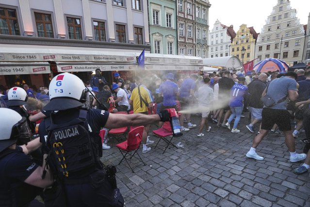 Police spray tear gas at Chelsea fans ahead of the Europa Conference League final soccer match between Real Betis and Chelsea in Wroclaw, Poland, Tuesday, May 27, 2025. (Photo by Czarek Sokolowski/AP Photo)