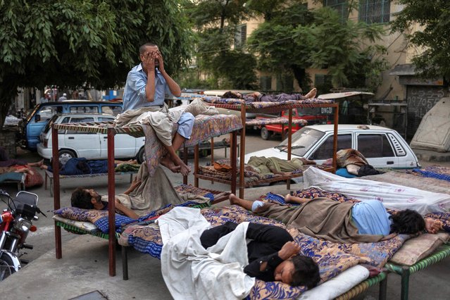 Gul Khattab, 35, awakens during a heatwave which forced residents to seek shelter outdoors in Rawalpindi, Pakistan, on May 23, 2025. (Photo by Adrees Latif/Reuters)