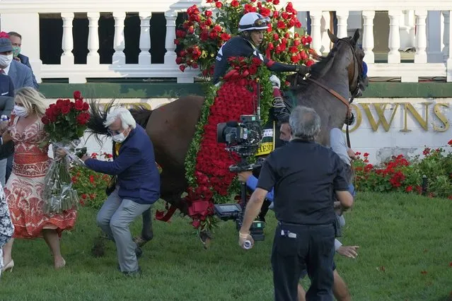 Trainer Bob Baffert is knocked to ground as Jockey John Velazquez try to control Authentic in the winners' circle after winning the 146th running of the Kentucky Derby at Churchill Downs, Saturday, September 5, 2020, in Louisville, Ky. (Photo by Jeff Roberson/AP Photo)