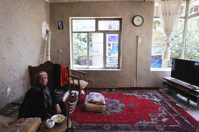 A woman sits inside her damaged house at an impact site following the Israeli strikes on Iran, in Tehran, on June 14, 2025. (Photo by Majid Asgaripour/WANA (West Asia News Agency) via Reuters)