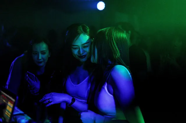 People dance inside the disco bar on September 18, 2020 in Wuhan, Hubei province, China. As there have been no recorded cases of community transmission in Wuhan since May, life for residents is returning to normal. (Photo by Getty Images)