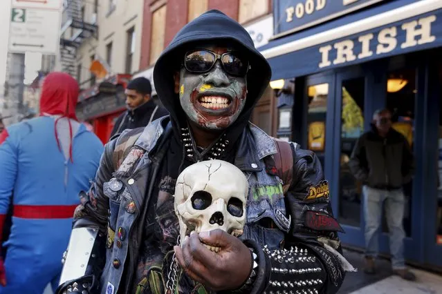 A man stands in costume outside a pub during the NYC Zombie Crawl in New York, October 18, 2015. (Photo by Shannon Stapleton/Reuters)