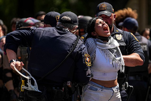 A pro-Palestinian protester yells “Free Palestine” as she is handcuffed by University of Texas at Austin police on the campus Monday, April 29, 2024, in Austin, Texas. (Photo by Aaron E. Martinez/Austin American-Statesman via AP Photo)