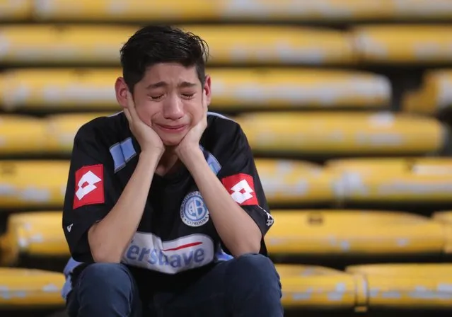 A fan cries after argentina's Belgrano lost it's match against Brazil's Coritiba during a Copa Sudamericana soccer match in Cordoba, Argentina, Thursday, September 29, 2016. (Photo by Nicolas Aguilera/AP Photo)