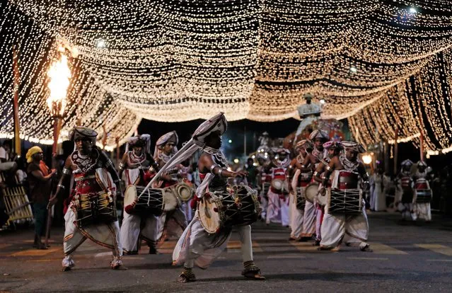 Sri Lankan traditional dancers perform during the annual Perahera (street pageant) at Kotte Raja Maha Viharaya Buddhist temple in Colombo, Sri Lanka, August 29, 2020. (Photo by Dinuka Liyanawatte/Reuters)