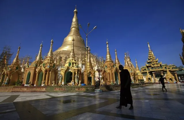 A Buddhist monk walks on the grounds of the Shwedagon pagoda in Yangon on March 18, 2013. (Photo by Soe Zeya Tun/Reuters)