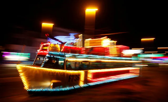 An illuminated tram in the shape of a boat passes under the illuminations on the promenade in Blackpool, northern England October 13, 2016. (Photo by Phil Noble/Reuters)