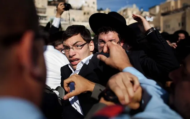 Ultra-Orthodox protesters clash with Israeli police officers during the prayer service held by the “Women Of The Wall”, on May 10, 2013. (Photo by Uriel Sinai/Getty Images)