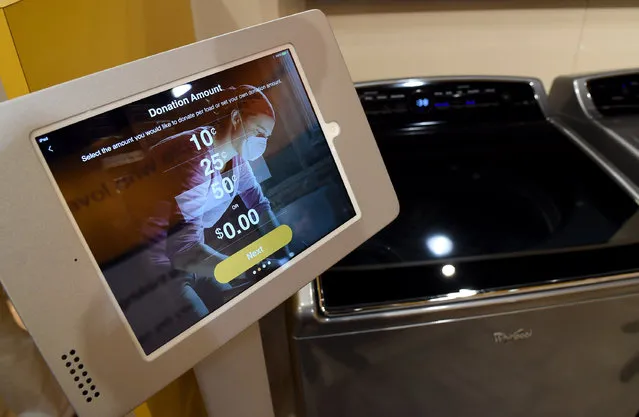 Whirlpool's new Smart Top Load washer is displayed at the 2015 International CES at the Sands Expo and Convention Center on January 6, 2015 in Las Vegas, Nevada. The unit can connect with the Nest Learning Thermostat remotely and offer custom downloadable cycles. Through Whirlpool's Connect to care program on the Whirlpool Mobile app, users can choose to donate any mount of money per load of laundry to Whirlpool's corporate partner, Habitat for Humanity. (Photo by Ethan Miller/Getty Images)