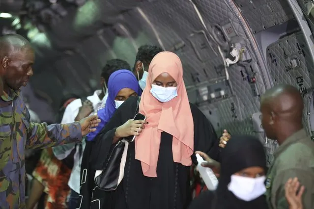 Aboard a Kenya Air Force plane, the first group of Kenyan evacuees from Sudan arrive at Jomo Kenyatta International Airport in Nairobi, Kenya, on Monday, April 24, 2023. As fighting continues in Sudan, several countries have evacuated their citizens. (Photo by Brian Inganga/AP Photo)
