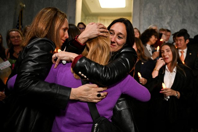 National Director of World Without Exploitation Lauren Hersh embraces Jeffrey Epstein survivor Liz Stein as they react to the Senate's passing of the bill to force the release of files related to the late convicted s*x offender Jeffrey Epstein, on Capitol Hill in Washington on November 18, 2025. (Photo by Annabelle Gordon/Reuters)
