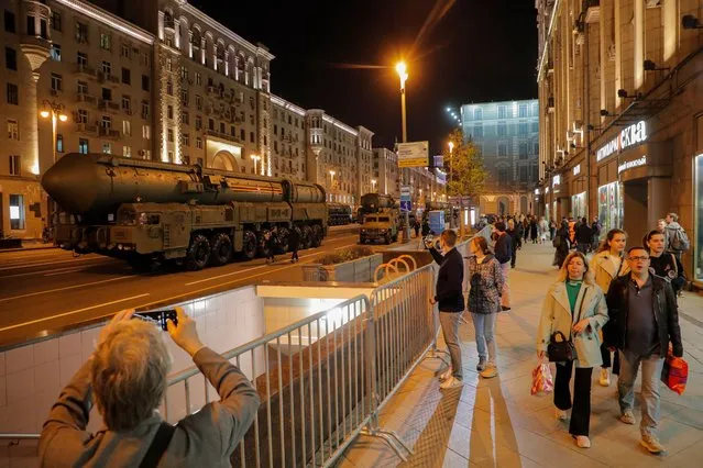 Russian people watch as a Yars intercontinental ballistic missile launcher drives on Tverskaya street in Moscow, Russia, 27 April 2023, during a rehearsal of the military parade which will take place on the Red Square on 09 May to commemorate the victory of the Soviet Union's Red Army over Nazi-Germany in WWII. (Photo by Maxim Shipenkov/EPA/EFE)