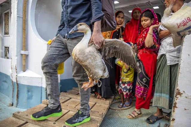 A Bangladeshi man carries a duck as he returns to Dhaka after Eid-al-Fitr celebrations, at the Sadarghat launch terminal in Dhaka, Bangladesh, 28 April 2023. Muslims around the world celebrate Eid al-Fitr, the three-day festival at the end of the Muslim holy fasting month of Ramadan. Eid al-Fitr is one of the two major holidays in Islam. (Photo by Monirul Alam/EPA)