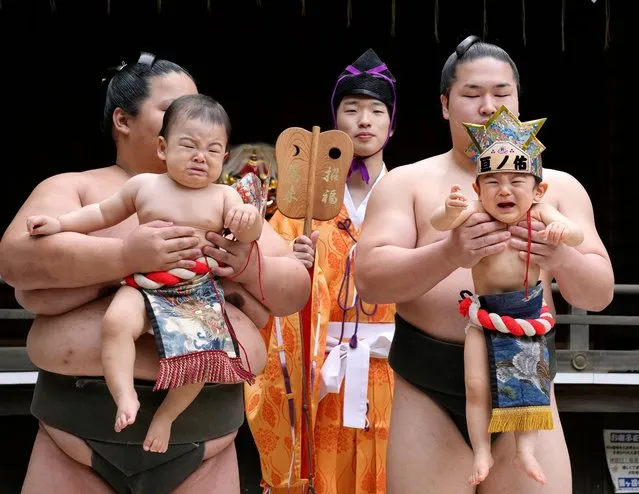 Sumo wrestlers hold babies during Nakizumo, the traditional baby crying contest, at Yukigaya Hachiman Shrine in Tokyo, Japan, 29 April 2023. Two babies held by each professional sumo wrestler compete to cry louder. The Nakizumo has been held all over Japan to pray for babies' health and growth as it is believed that babies crying louder are strong to ward off evil. A referee is in the center and sometimes uses a devil mask to scare the babies if they do not start crying. About 100 babies from six-month-old to two and a half-year-old participated in the babies crying contest. (Photo by Kimimasa Mayama/EPA/EFE/Rex Features/Shutterstock)