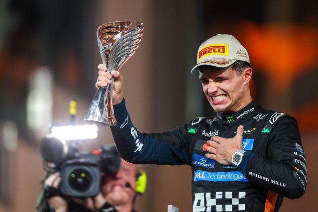 Lando Norris of Great Britain and McLaren raises his trophy in celebration on the podium during the F1 Grand Prix of Abu Dhabi at Yas Marina Circuit on December 7, 2025 in Abu Dhabi, United Arab Emirates. (Photo by Jayce Illman/Getty Images)