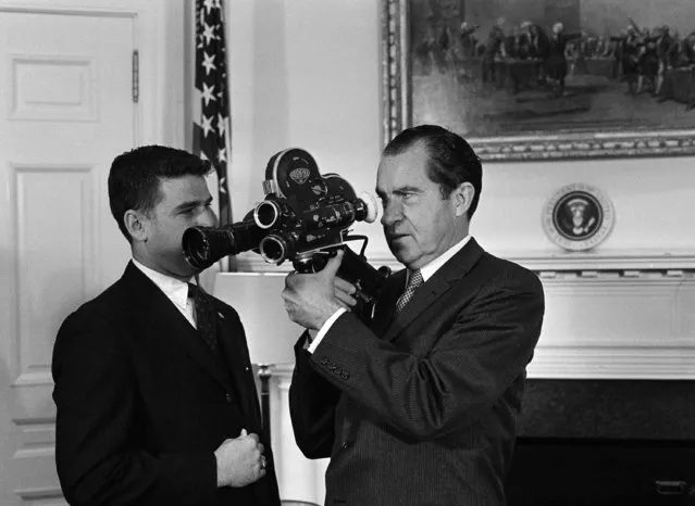 Pres. Richard Nixon, right, sights through the view of a movie camera as he met Bob Welch, cameraman for National Broadcasting Company, award winner of the White House. News Photographers Association photo content, in his White House office, March 20, 1969, Washington, D.C. (Photo by Bob Daugherty/AP Photo)