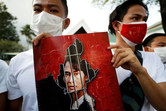 Myanmar citizens hold up a picture of leader Aung San Suu Kyi after the military seized power in a coup in Myanmar, outside United Nations venue in Bangkok, Thailand on February 2, 2021. (Photo by Jorge Silva/Reuters)