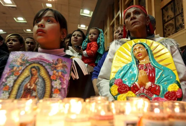 Pilgrims hold up images of the Virgin of Guadalupe during an annual pilgrimage in honor of the Virgin, the patron saint of Mexican Catholics, at the Cathedral of Ciudad Juarez, Mexico December 11, 2015. (Photo by Jose Luis Gonzalez/Reuters)