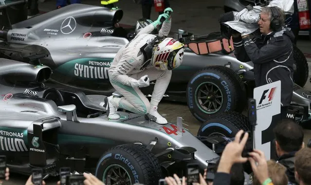 Formula One, F1, Brazilian Grand Prix, Circuit of Interlagos, Sao Paulo, Brazil on November 13, 2016. Mercedes' Lewis Hamilton of Britain celebrates atop his car after winning the race. (Photo by Paulo Whitaker/Reuters)