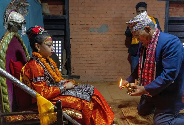 Mayor of Patan city Chiribabu Maharjan speaks while living goddess Kumari Niharika Bajracharya (L) listens at Ga Bahal in Lalitpur, Nepal, 02 May 2023. (Photo by Narendra Shrestha/EPA/EFE)