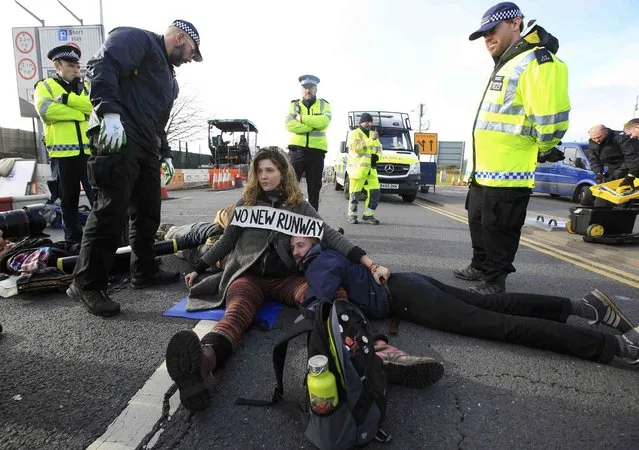 Environmental protestors block a road during a protest near Heathrow airport in west London, Britain November 19, 2016. (Photo by Paul Hackett/Reuters)