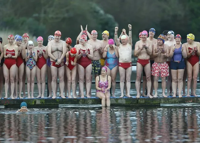 Swimmers cheer as the first participant begins the annual Christmas Day Peter Pan Cup handicap race in the Serpentine River, in Hyde Park, London, December 25, 2015. (Photo by Andrew Winning/Reuters)